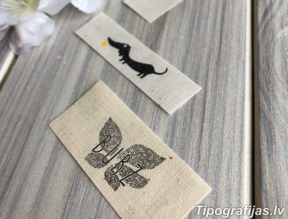 Manufacturing and printing textile tags with a design